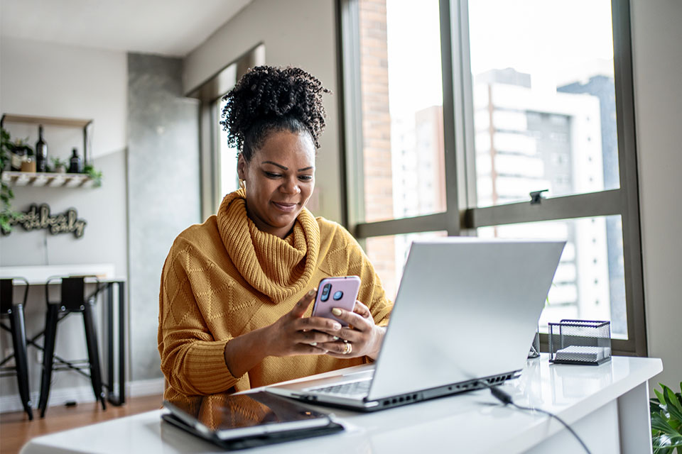 Woman on her phone at home reporting fraud.