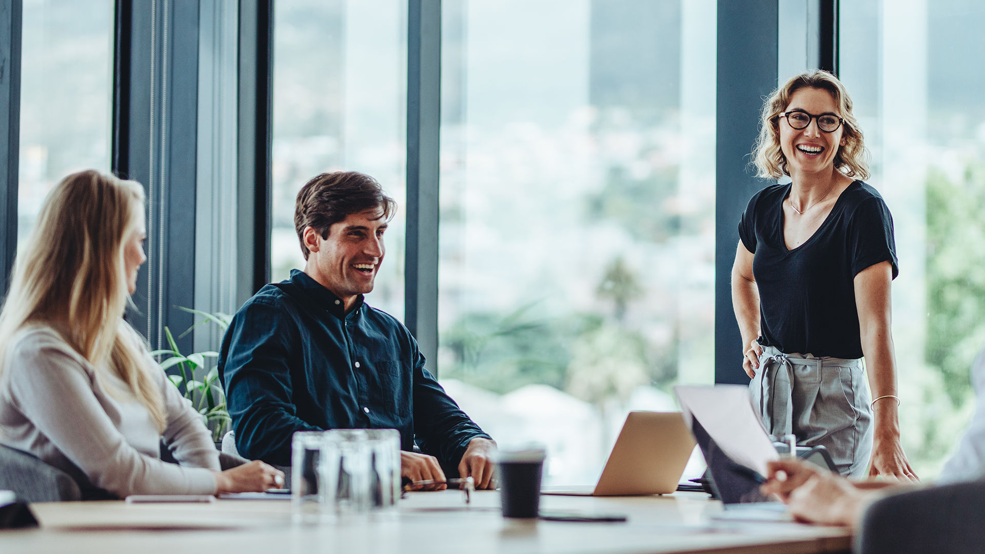 Three happy work collegues in an office dicussing new career options