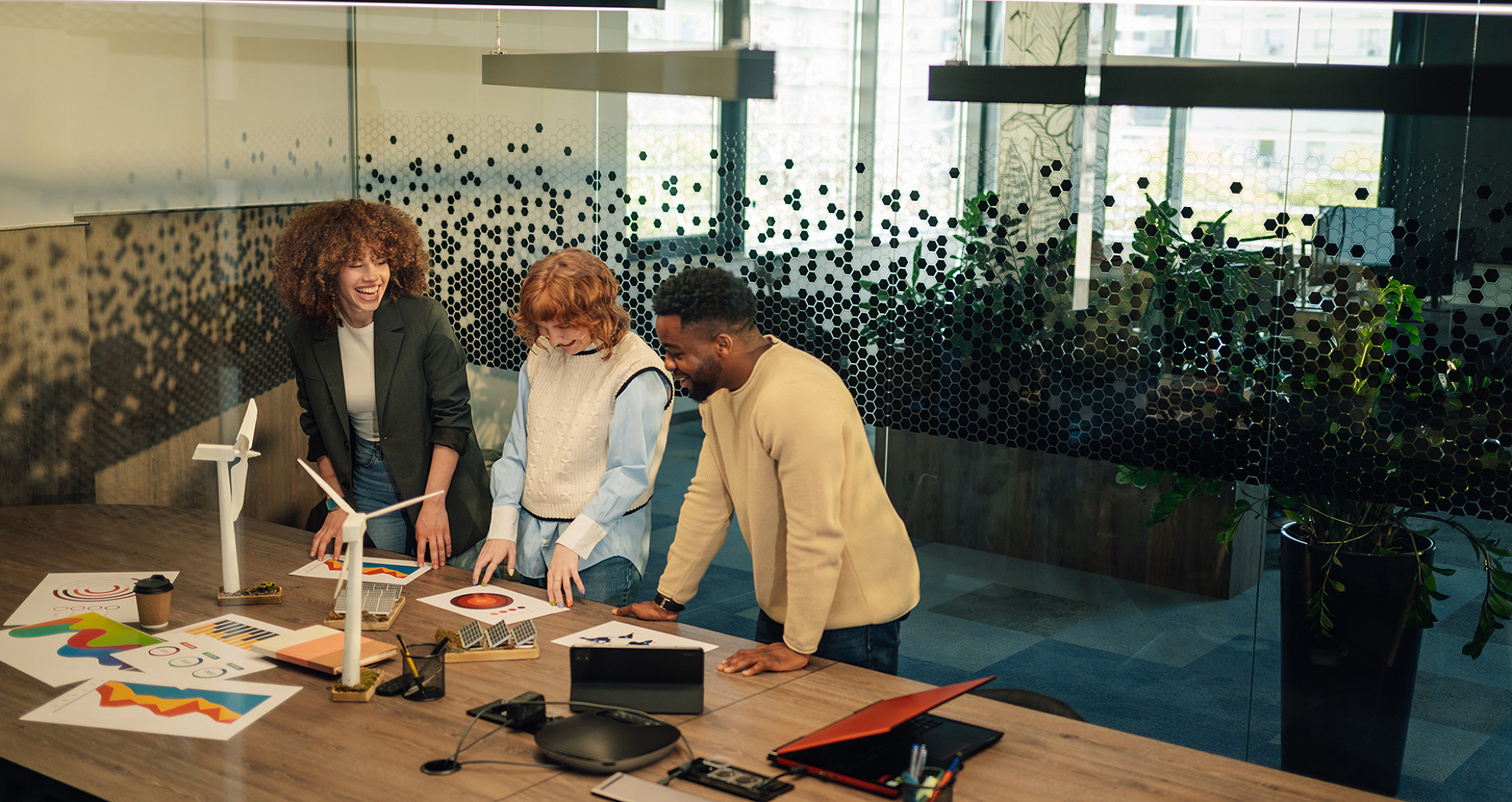 Three happy work collegues in an office dicussing new career options