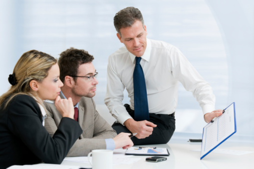 3 colleagues reviewing report