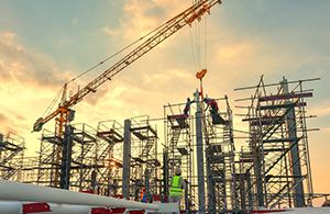 The early stages of a contruction site with a crane in view at twilight