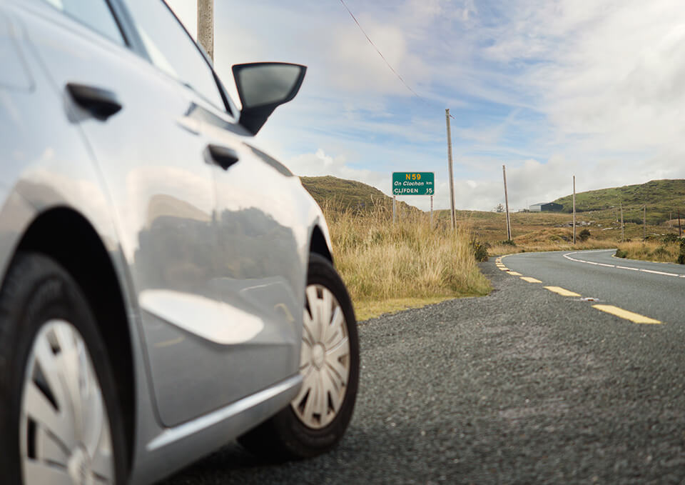 A close up, side view of  a car parked on the side of the road.